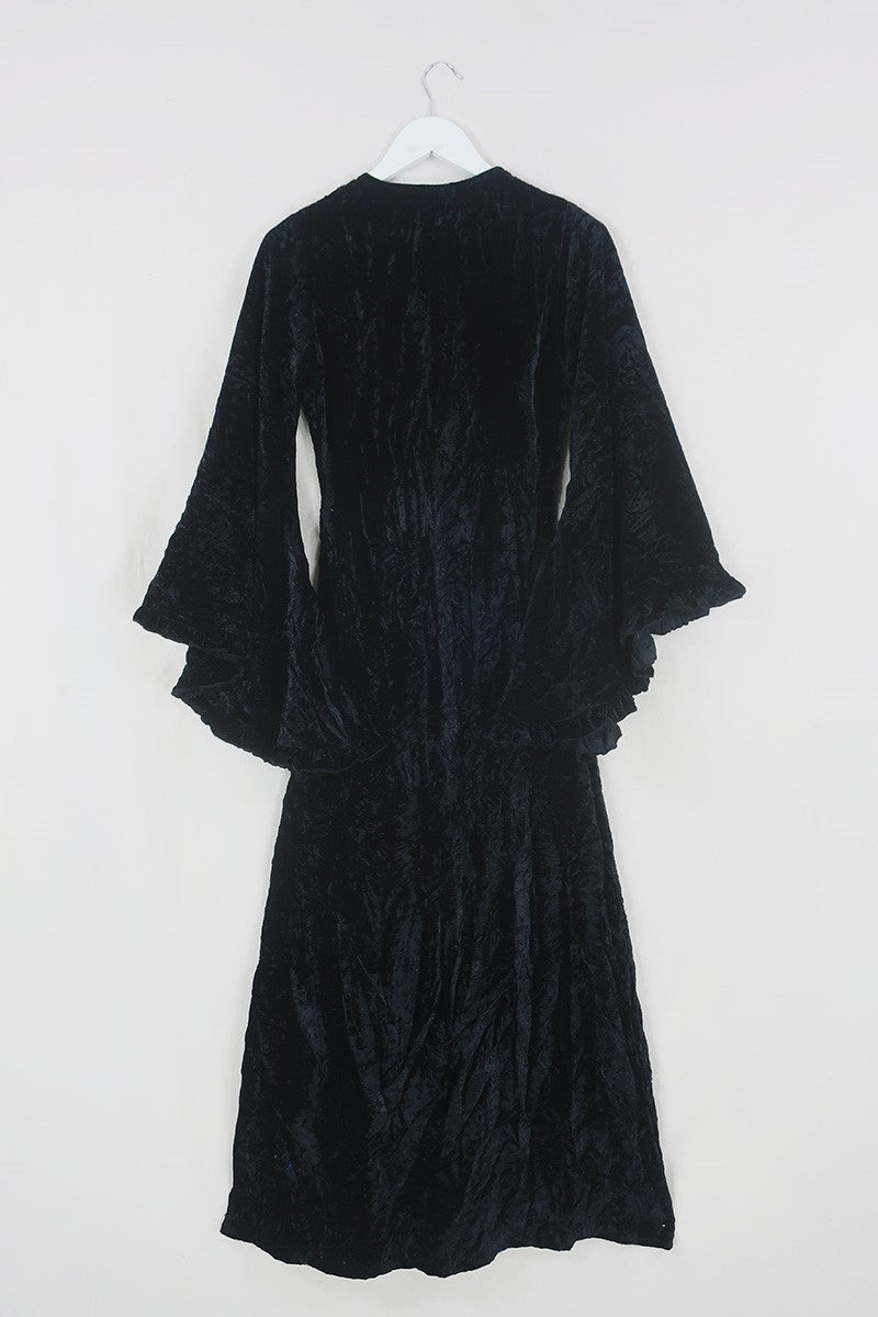 Flat lay of the back of our Venus Maxi Dress in Morticia Black Velvet tied at the front as a kimono by All About Audrey