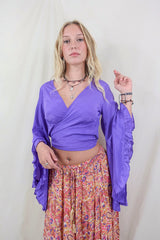 Model wearing electric violet Khroma Venus Top worn in a wrap style. Made from viscose fabric they're silky and soft have an elegant shape all by all about audrey