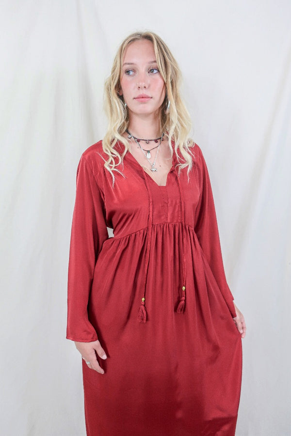 Model wears Ruby Red Khroma Gaia Kaftan Dress. Inspired by the hippie bohemian 70s style. Wear loose or wrap around with a tie for a more fitted look. Made from a soft silky viscose fabric that hangs beautifully by All About Audrey
