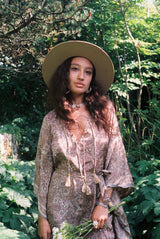 Model wears our Sierra hat in Fawn. A light natural beige inspired by vintage 1970s prairie and western cowboy styles. Classic wide brim and high crown Fedora design with a decorative thin ribbon and simple brim by All About Audrey