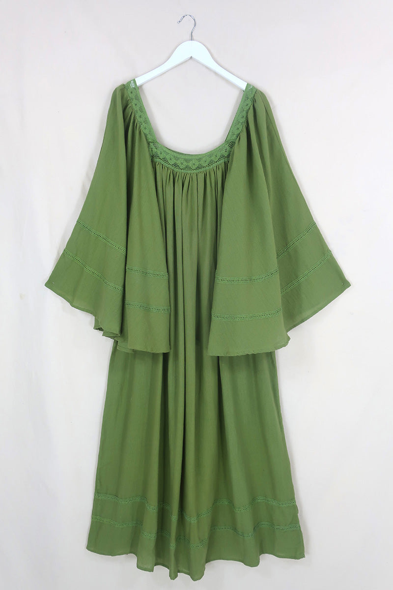 Flat lay of our Raven Maxi Dress in Pixie Green. A loose smock style with folky crochet neckline and sleeves By All About Audrey