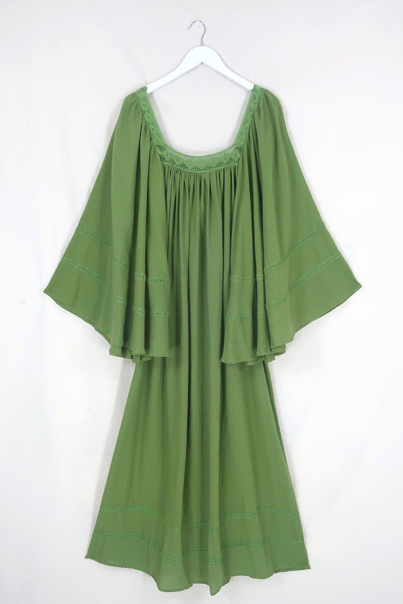 Flat lay of our Raven Maxi Dress in Pixie Green. A loose smock style with folky crochet neckline and sleeves By All About Audrey