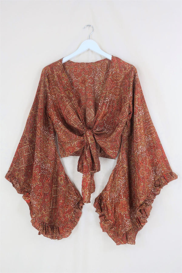 A beautiful mix of 70s inspired earthy brown, gold and orange tones. The Hendrix Orange mandala Venus top is inspired by 70's bohemia with its wrap style front and huge bell sleeves by All About Audrey