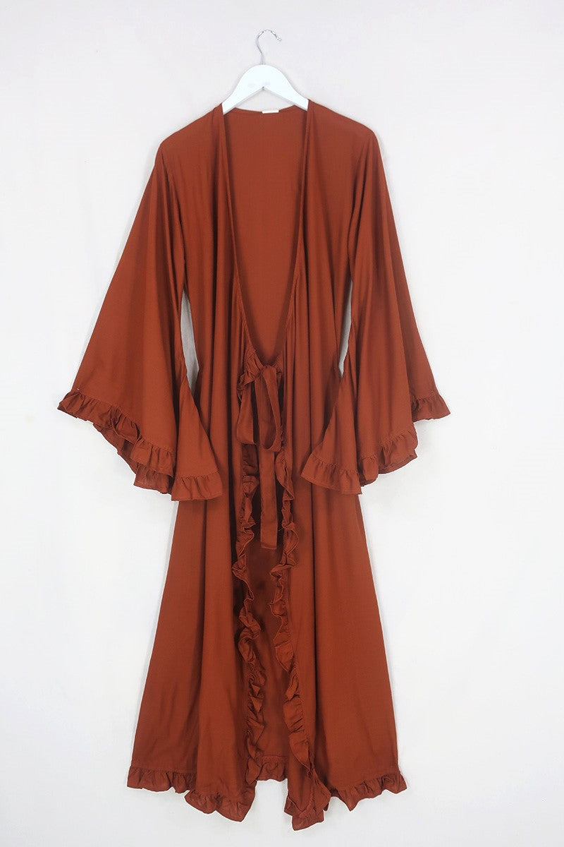 Flat lay of our Khroma Venus Robe Dress in Red Clay shown tied at the front in a robe style by All About Audrey