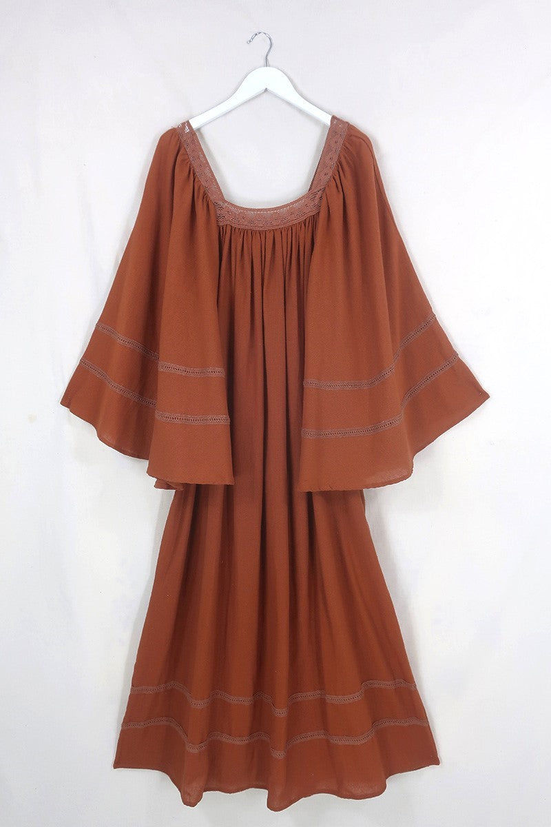 Flat lay of our Raven Maxi Dress in Red Clay by All About Audrey