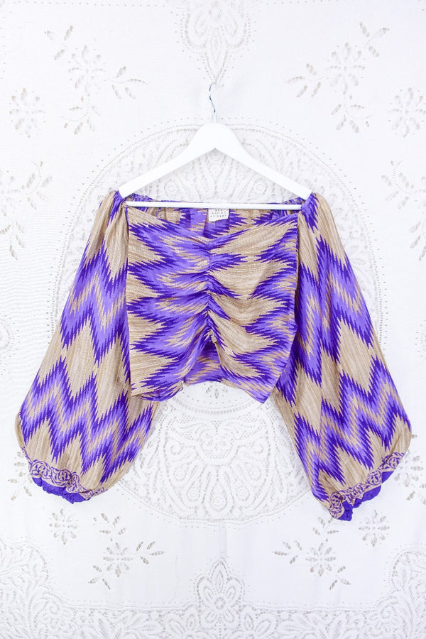 Our Ariel top with sweetheart neckline and ruched bust is flattering on all body types. This beauty has purple and mushroom tones within a bold chevron print. 