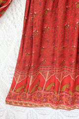 detail of hem on peacock primrose midi dress in berry red with gold detailed vintage inspired indian peacock design from our collection of bohemian dresses by all about audrey