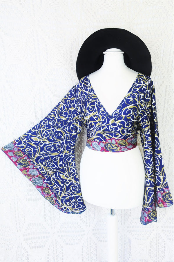 navy blue white and olive green block print with magenta and grey floral borders gemini boho bell sleeve wrap top photographed on a uk size 8 mannequin by all about audrey
