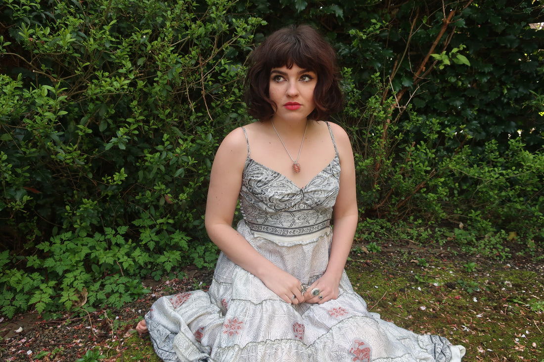 photo of model wearing white floral pattern Delilah tiered elasticated maxi dress by all about audrey