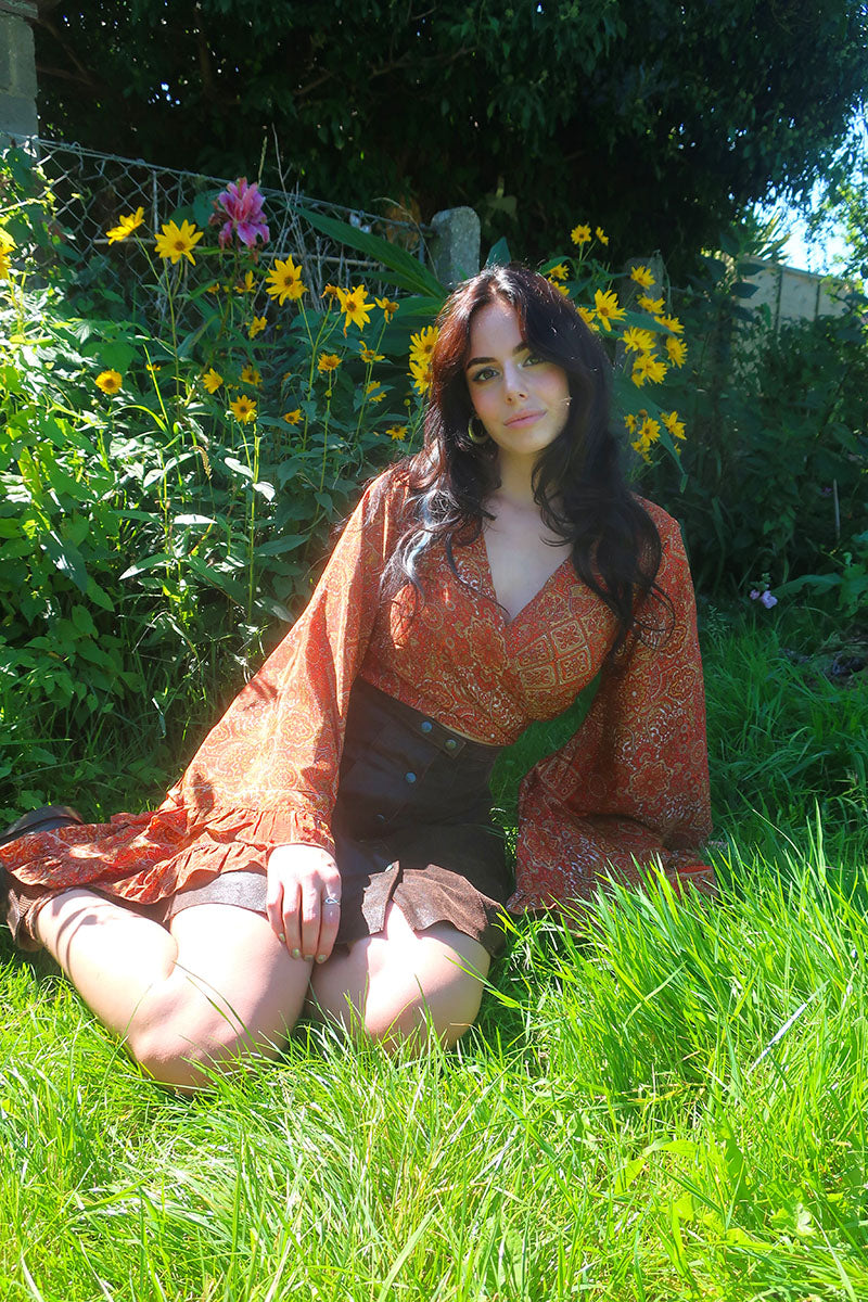 A beautiful mix of 70s inspired earthy brown, gold and orange tones. The Hendrix Orange mandala Venus top is inspired by 70's bohemia with its wrap style front and huge bell sleeves by All About Audrey