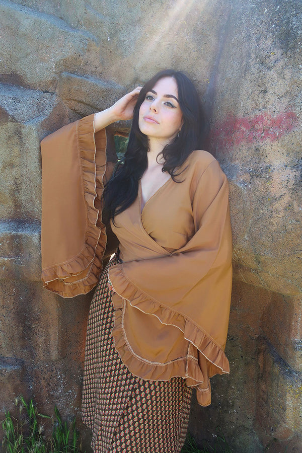 model image of our Venus Khroma wrap top in Golden Sands, a neutral, earthy, antique gold tone which is easy to style and versatile to wear! Inspired by 70's bohemia by All About Audrey