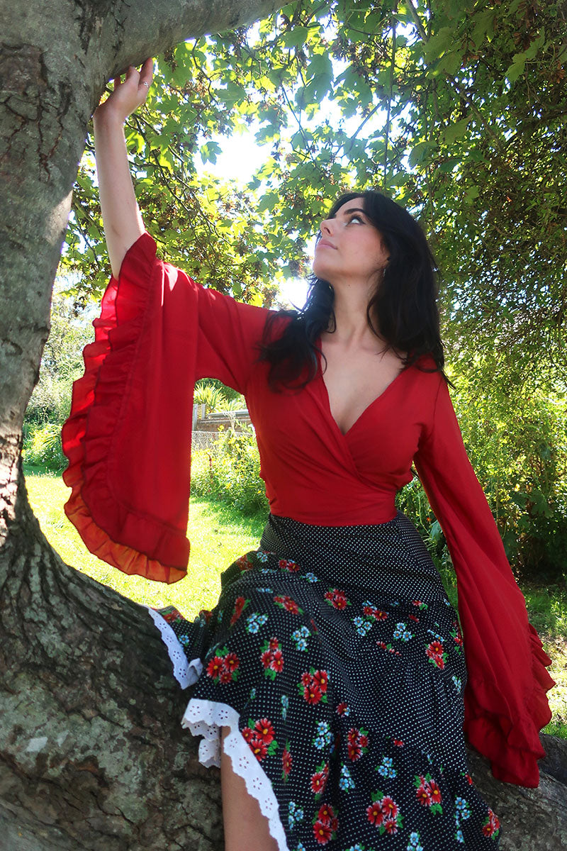 model image of our Venus Khroma wrap top in Scarlet Red, a spicy and bold classic which is easy to style and versatile to wear! Inspired by 70's bohemia by All About Audrey