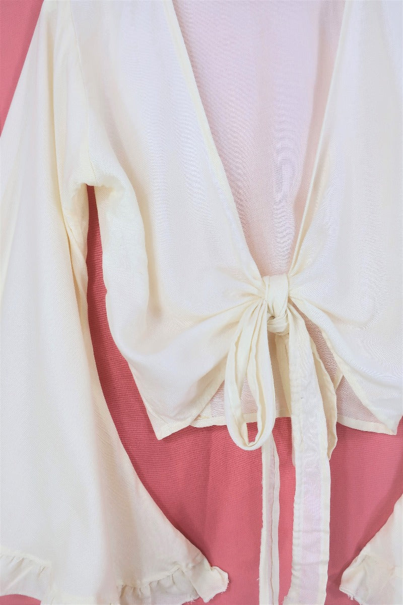 Close up of our Venus bell sleeve frill top in 'Coconut Cream'. Very versatile, can be tied at the front, wrapped around or even worn backwards. Handmade from a soft breathable rayon fabric by All About Audrey. 