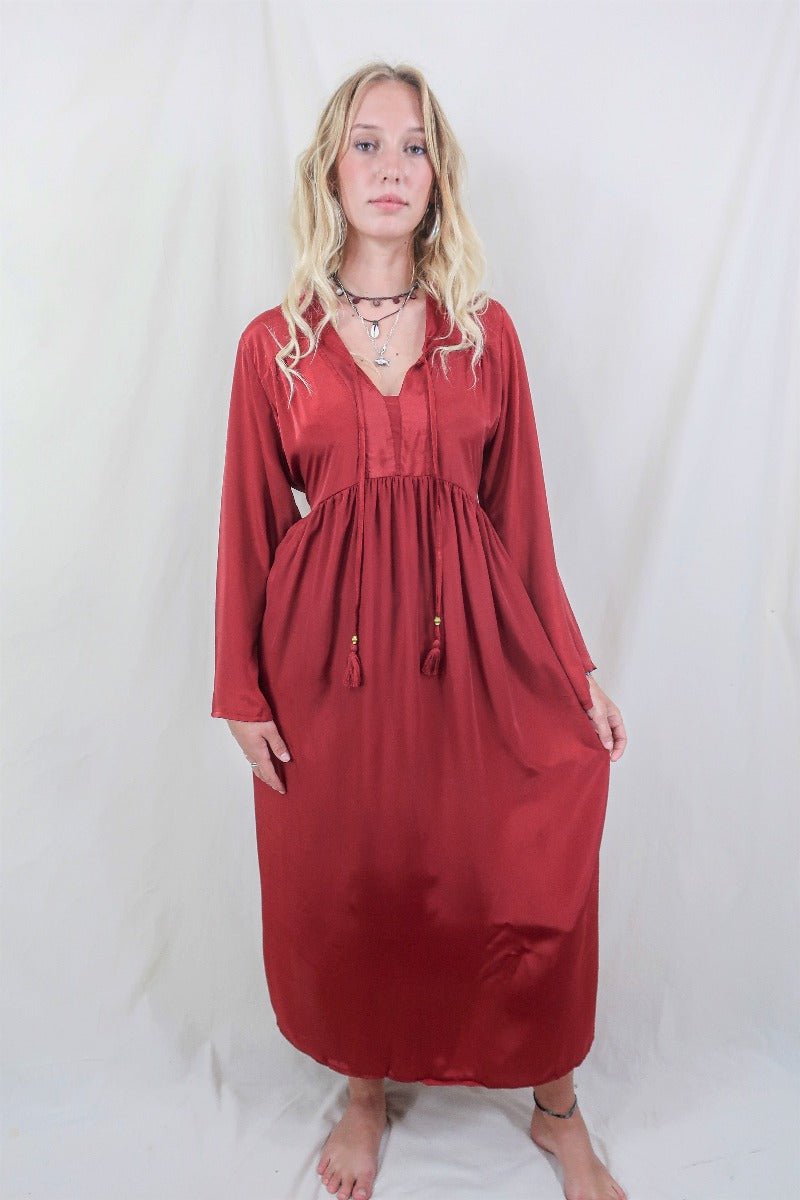 Model wears Ruby Red Khroma Gaia Kaftan Dress. Inspired by the hippie bohemian 70s style. Wear loose or wrap around with a tie for a more fitted look. Made from a soft silky viscose fabric that hangs beautifully by All About Audrey