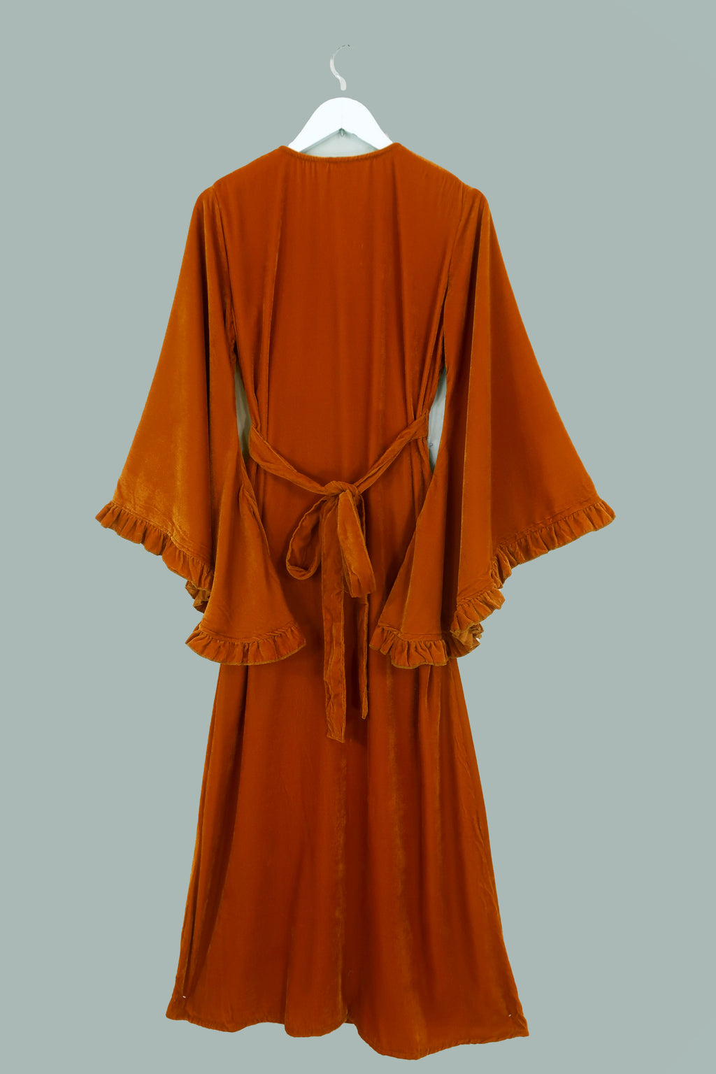 Behind flat lay of our Khroma Venus Maxi Dress in Marmalade Yellow Velvet. Showing the dress wrapped around and tied at the back. A flattering vintage silhouette reminiscent of 1970s style by All About Audrey