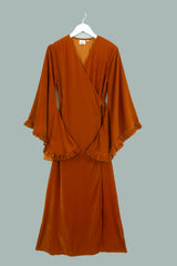 Flat lay of our Khroma Venus Maxi Dress in Marmalade Yellow Velvet. Showing the dress wrapped around and tied at the back. A flattering vintage silhouette reminiscent of 1970s style by All About Audrey