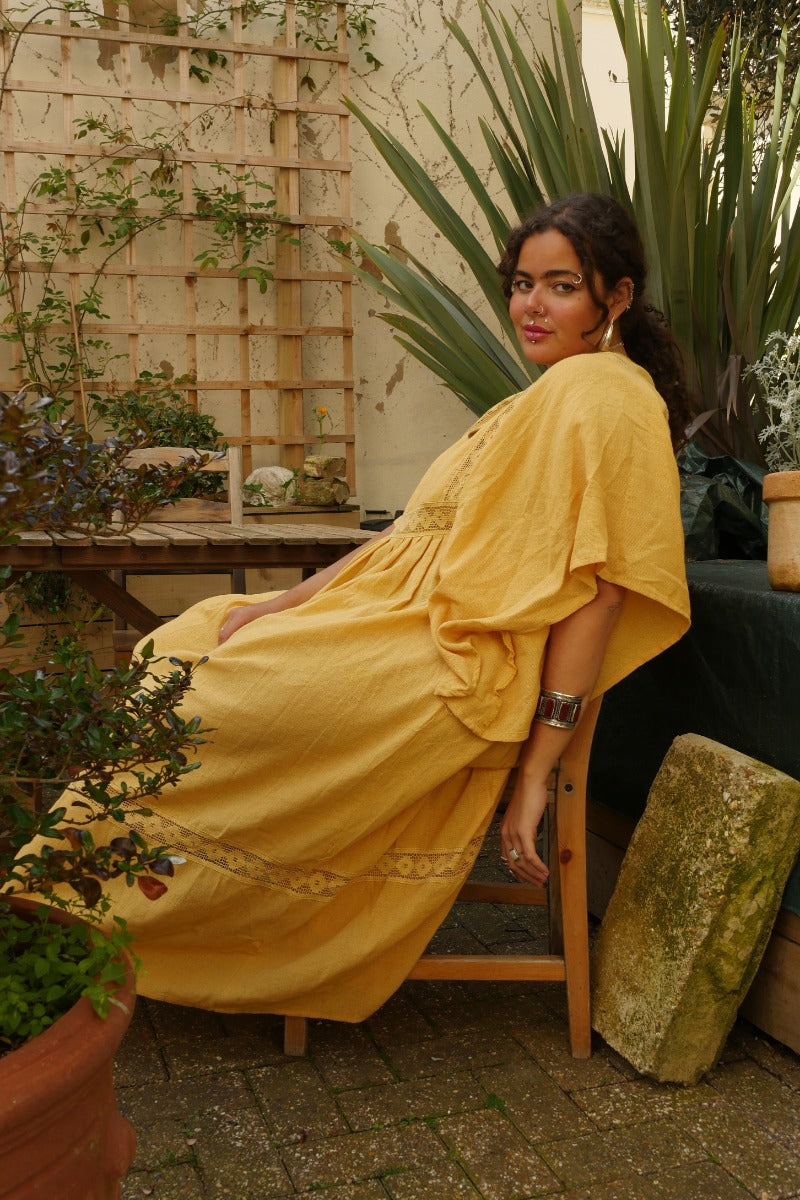 Model wears our Cordelia Midi Dress in Daffodil Yellow. A beautiful folky and bohemian style with it's crochet bust panel and skirt. Such a lovely sun kissed yellow tone by All About Audrey