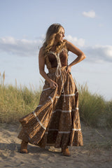 Model wears our Darcy Maxi Dress in Forest Fawn Brown. A beauitful gunne sax inspired design with a velvet fitted laced bodice and flowing tiered cotton skirt of wildflowers. By All About Audrey