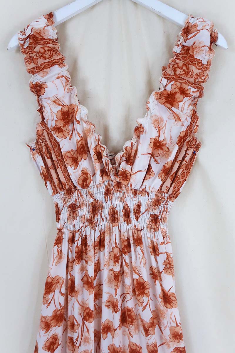 Flat lay of Maisie Maxi Dress in Candied Orange Watercolour Floral, a retro floaty frill dress inspired by the 70s bohemian fashion by All About Audrey