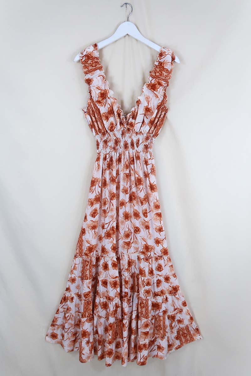 Flat lay of Maisie Maxi Dress in Candied Orange Watercolour Floral, a retro floaty frill dress inspired by the 70s bohemian fashion by All About Audrey