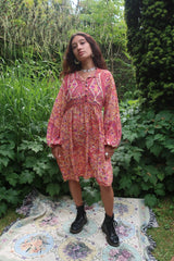 model wears florence mini short bohemian style dress with balloon sleeve and button down contrast yolk in flower and paisley print colour ivory violet and rose by all about audrey