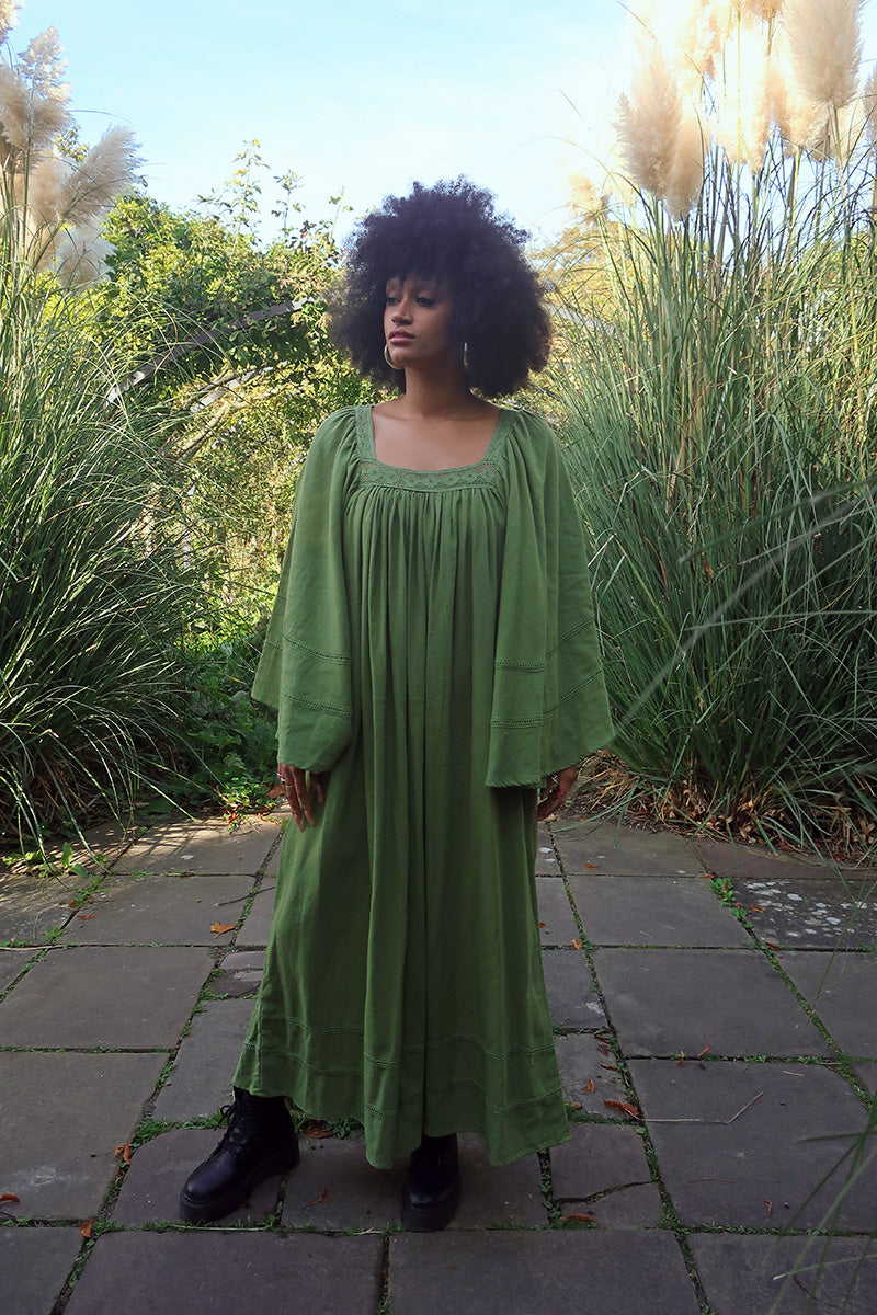 Model wears our Raven Maxi Dress in Pixie Green. A loose smock style with folky crochet neckline and sleeves. Wear loose or belted for a more fitted look. By All About Audrey
