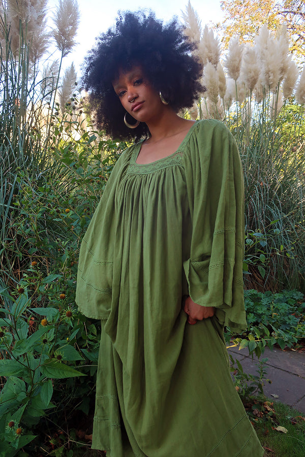 Model wears our Raven Maxi Dress in Pixie Green. A loose smock style with folky crochet neckline and sleeves. Wear loose or belted for a more fitted look. By All About Audrey
