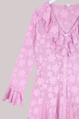 Pink floral dress with ruffled sleeves on a gray background