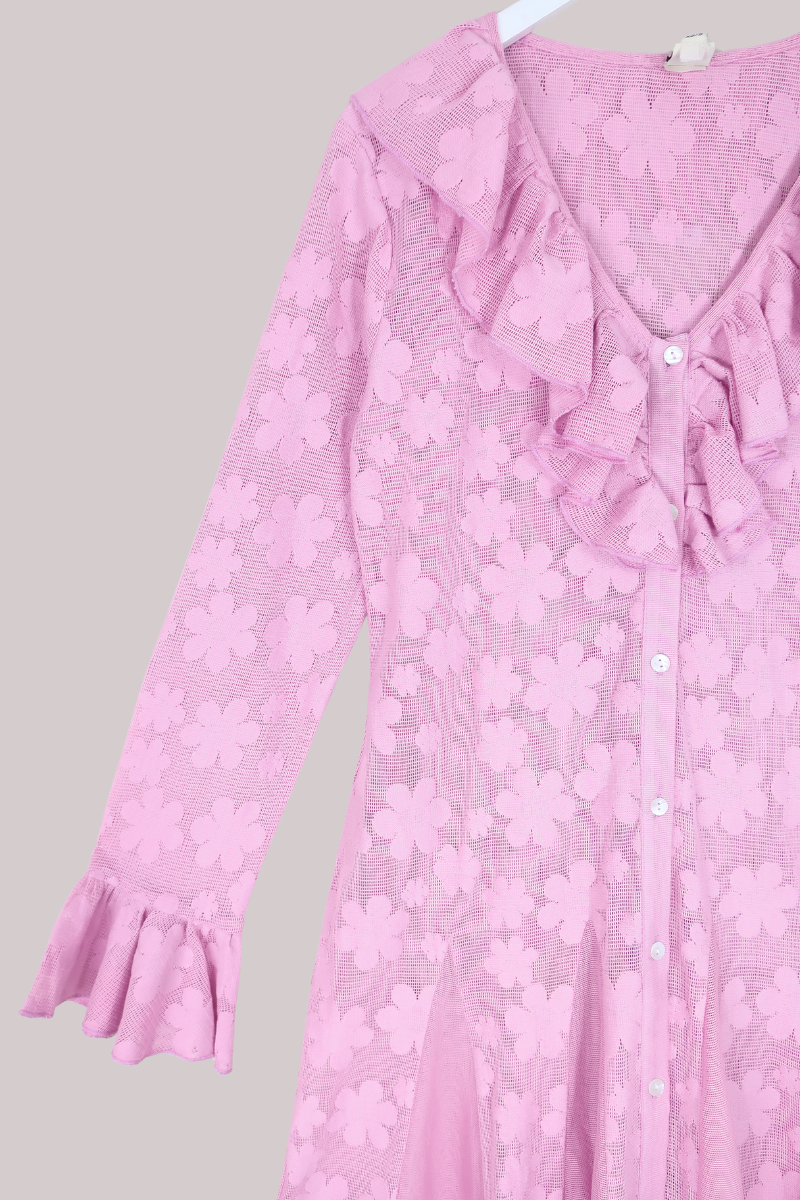 Pink floral dress with ruffled sleeves on a gray background