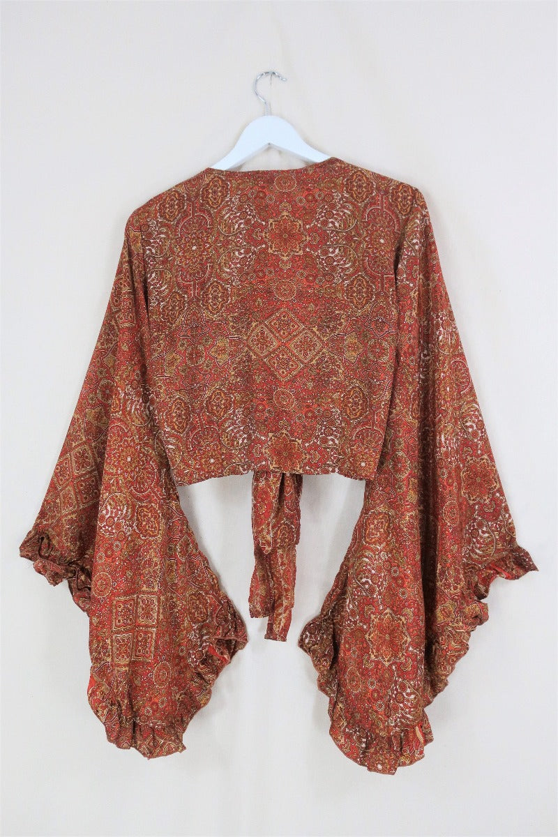 A beautiful mix of 70s inspired earthy brown, gold and orange tones. The Hendrix Orange mandala Venus top is inspired by 70's bohemia with its wrap style front and huge bell sleeves by All About Audrey
