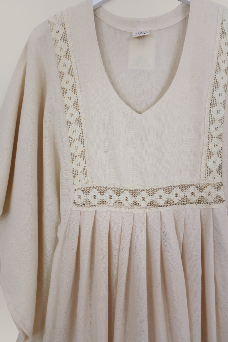 Flatlay of our Cordelia Midi Dress in Ivory White by All About Audrey