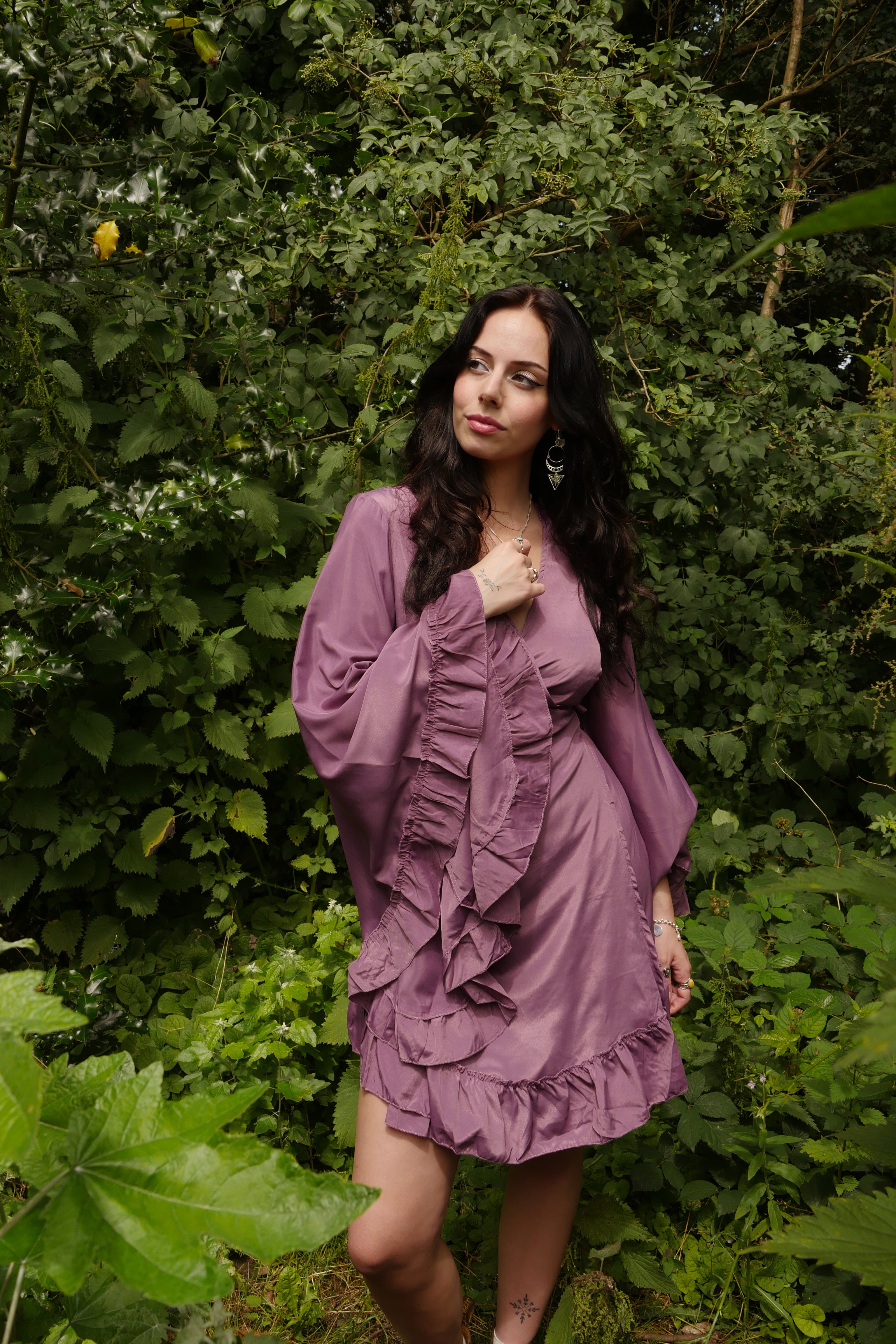 model wears Khroma Venus Mini Wrap Dress in Lavender Purple by all about audrey