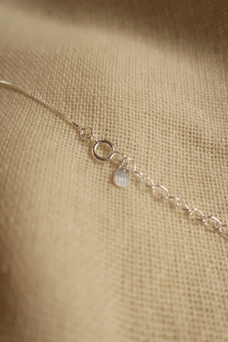 Silver Marigold Charm Necklace by All About Audrey