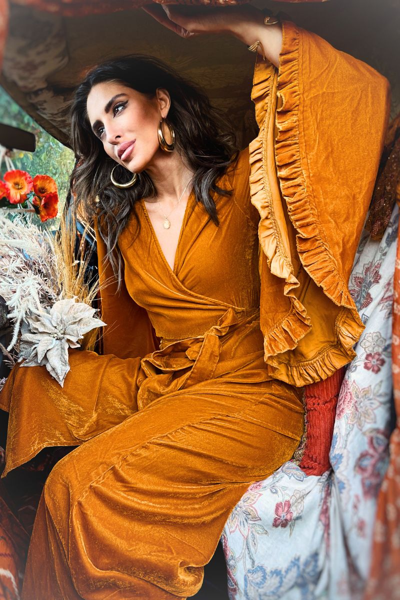 model wears khroma venus maxi dress in marmalade yellow velvet long 70s wrap dress with wide frilly bell sleeves golden mustard orange robe by all about audrey