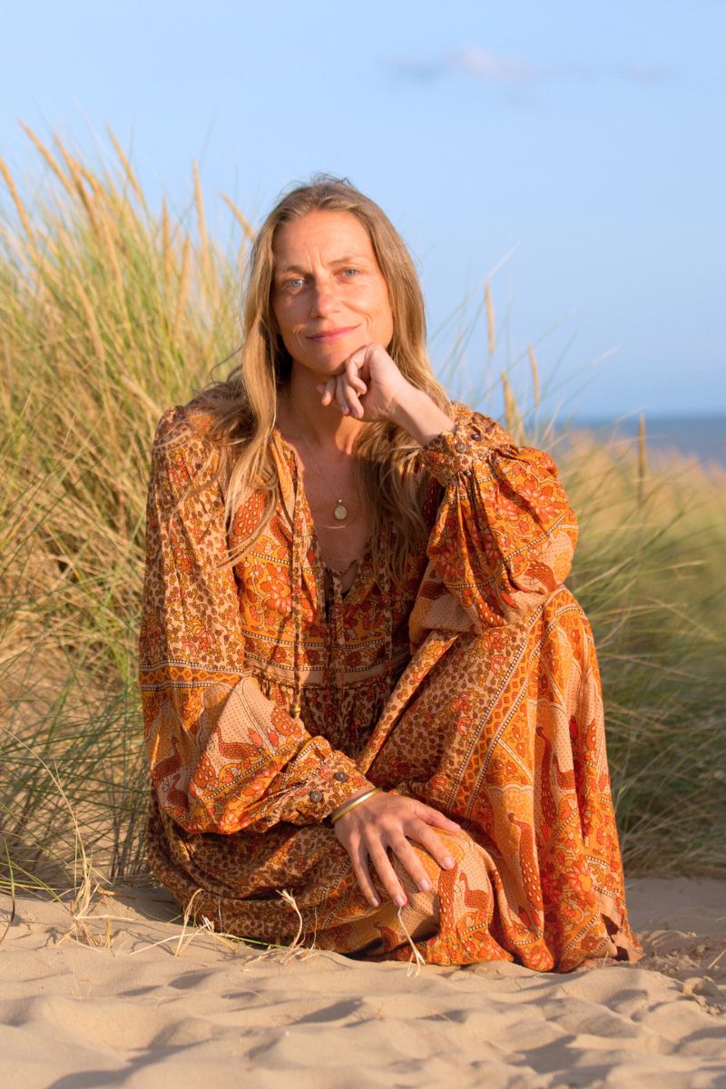 Beth wears our Peacock Primrose Dress in Tan & Tumeric. An earthy golden tone with a vintage inspired 1970s peacock, floral print. Worn loose and flowing by All About Audrey