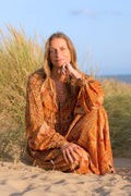 Beth wears our Peacock Primrose Dress in Tan & Tumeric. An earthy golden tone with a vintage inspired 1970s peacock, floral print. Worn loose and flowing by All About Audrey