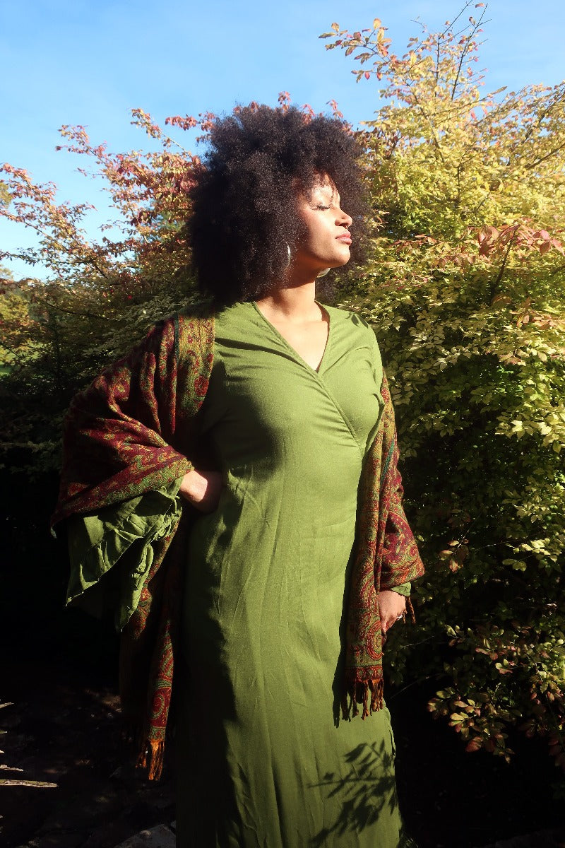 Model wears our Khroma Venus Robe Dress in Pixie Green as a wrap style dress. A retro 70's inspired design with frill trim on the sleeves and front. Handmade from soft rayon by All About Audrey