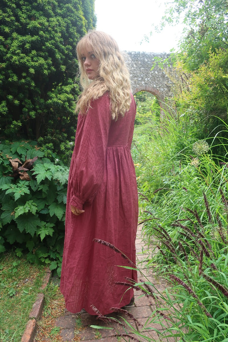 Model wears our retro bohemian inspired Khroma Primrose Dress in Purple Sangria. Made of Indian Cotton based off of 1970s bohemia fashion by All About Audrey