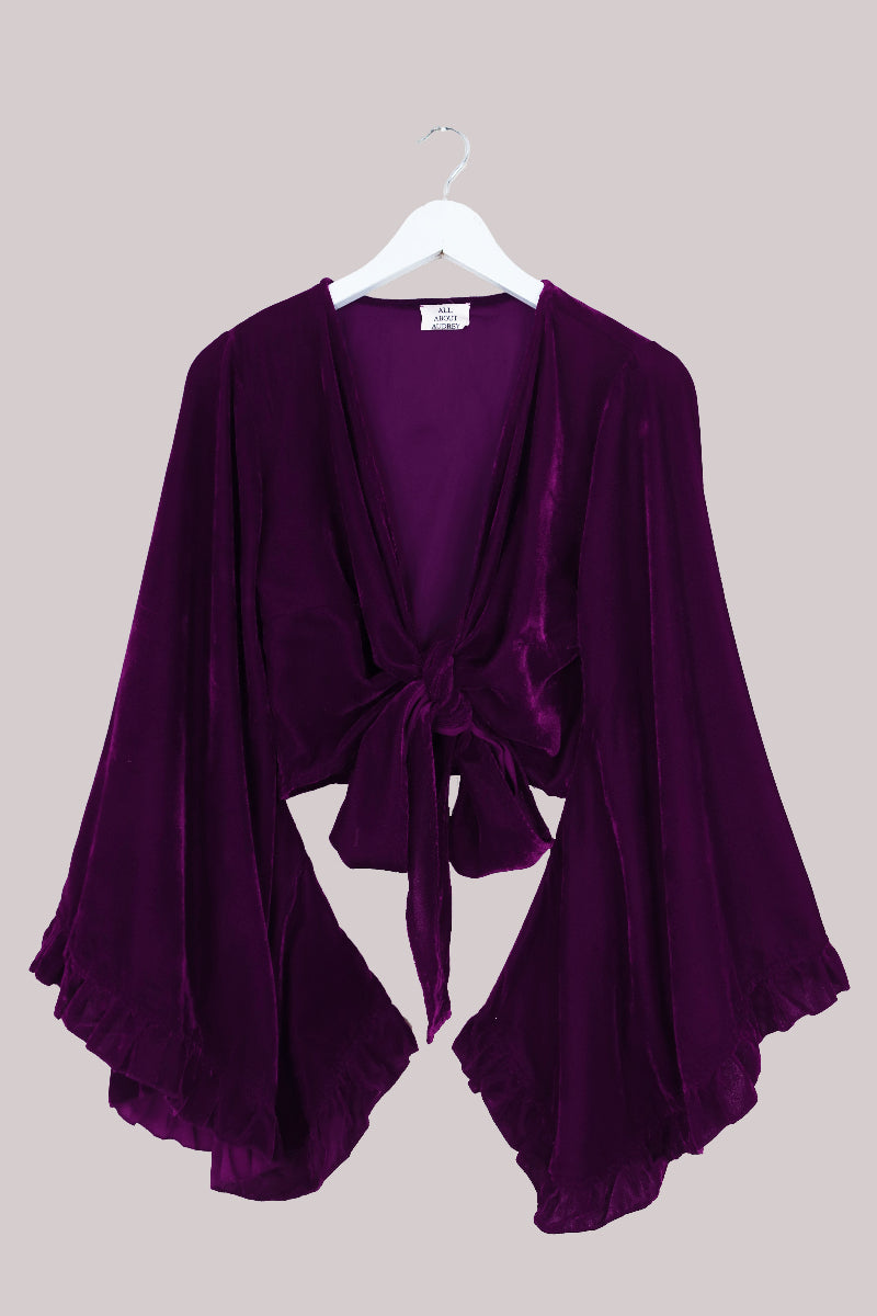 Vintage 1970's inspired velvet Venus top in Purple Quartz. A deep but vibrant jewel tone in a luxurious soft velvet. A tie wrap front with retro and iconic butterfly sleeves by All About Audrey