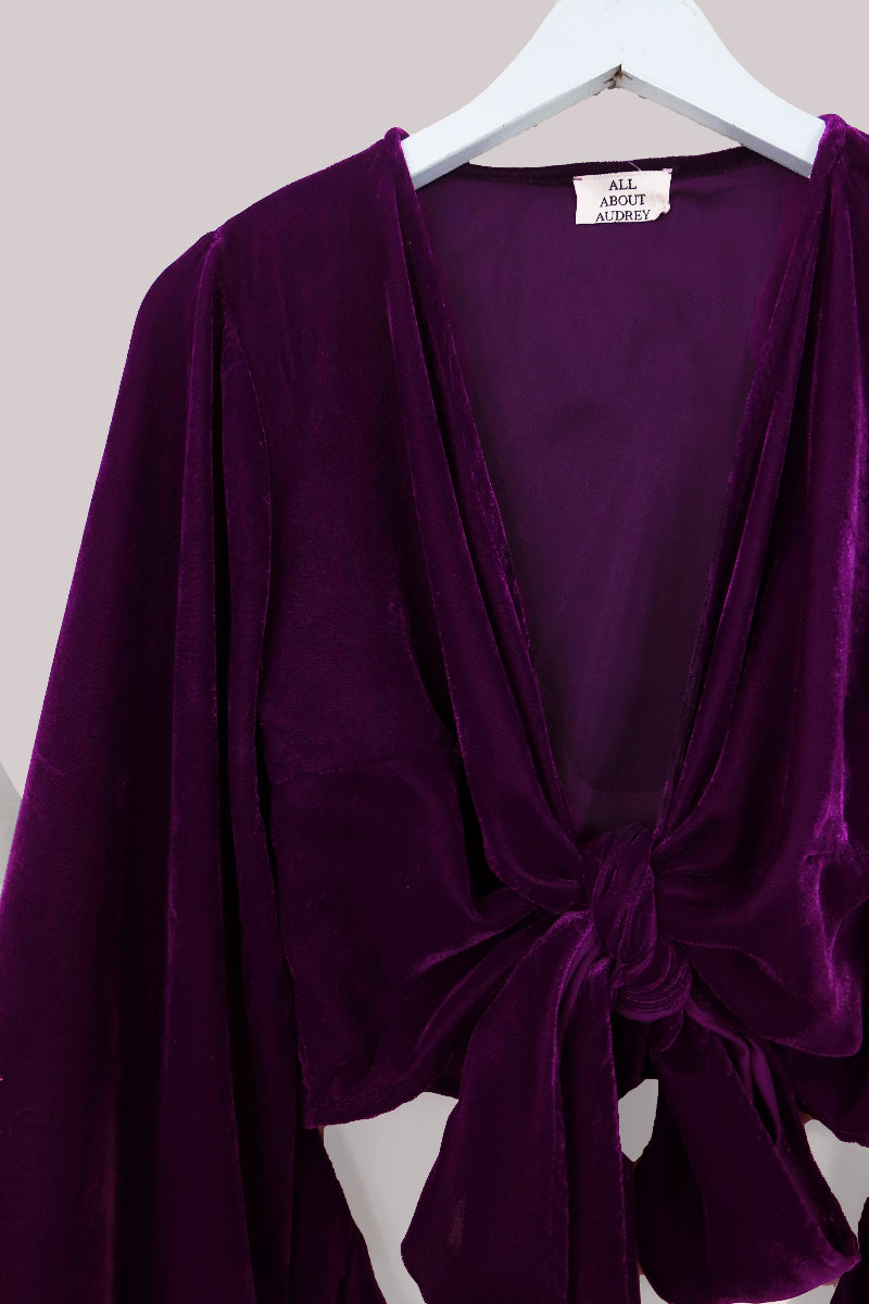 Vintage 1970's inspired velvet Venus top in Purple Quartz. A deep but vibrant jewel tone in a luxurious soft velvet. A tie wrap front with retro and iconic butterfly sleeves by All About Audrey