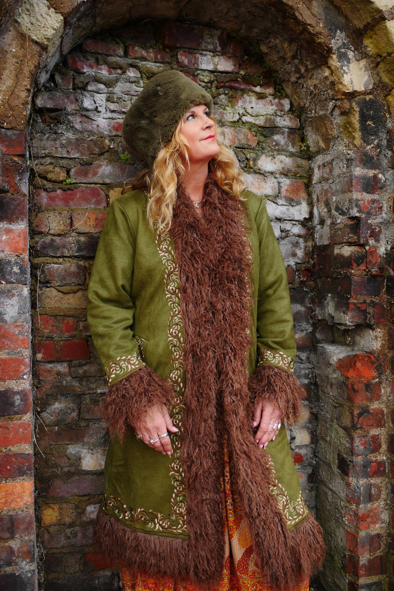 Audrey wears our Fleetwood Embroidered Coat in Rumours Green. A vintage 1970s inspired Afghan design in a warm, light olive tone and honey hue embroidery. By All About Audrey