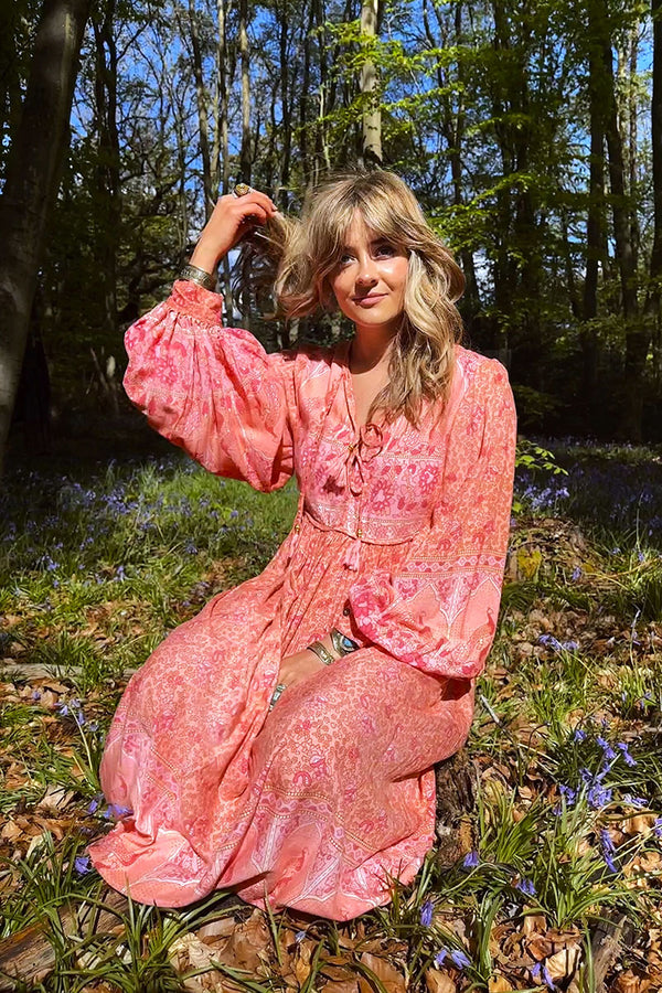 https://www.allaboutaudrey.co.uk/cdn/shop/files/susie-modelling-peacock-handmade-70s-midi-dress-in-peach-and-rose-monotone-pink-peacock-floral-print-long-balloon-sleeve-boho-prairie-dress-by-all-about-audrey_600x.jpg?v=1693994402