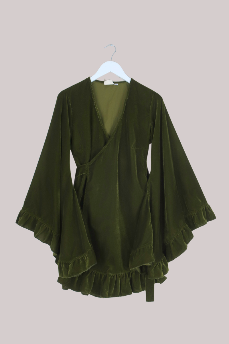 Green kimono-style garment on a hanger against a beige background