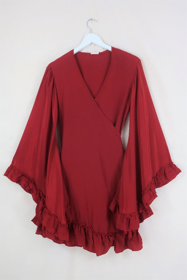 Flat lay of our Venus Khroma wrap dress in Scarlet Red, a spicy and bold red tone which is easy to style and versatile to wear! Inspired by 70's bohemia by All About Audrey