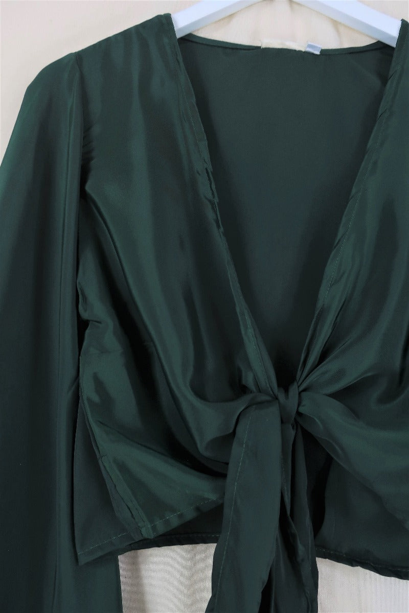 Flat lay of our Venus Khroma wrap top in Golden Sands, a neutral, earthy, antique gold tone which is easy to style and versatile to wear! Inspired by 70's bohemia by All About Audrey