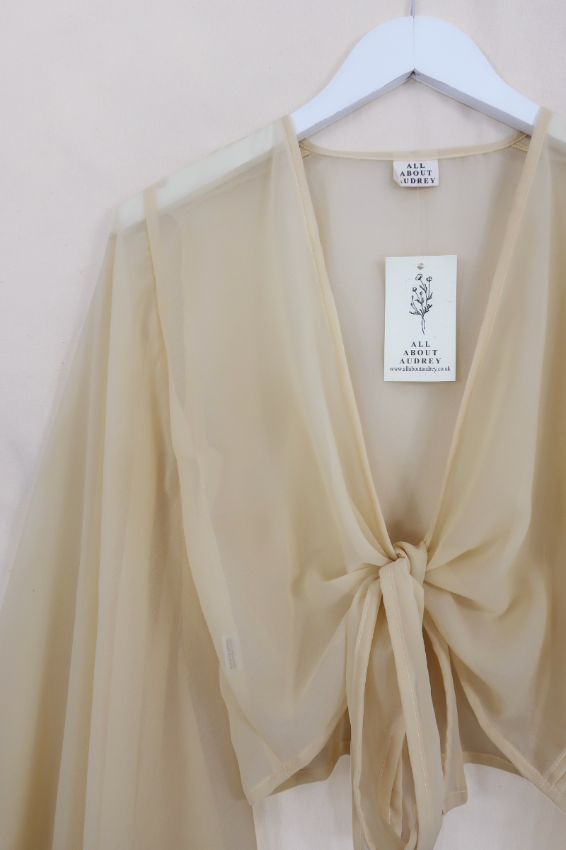 Birgo Shell Virgo Sheer Bell Sleeve Wrap Top | Shell White | All About Audrey – All ...