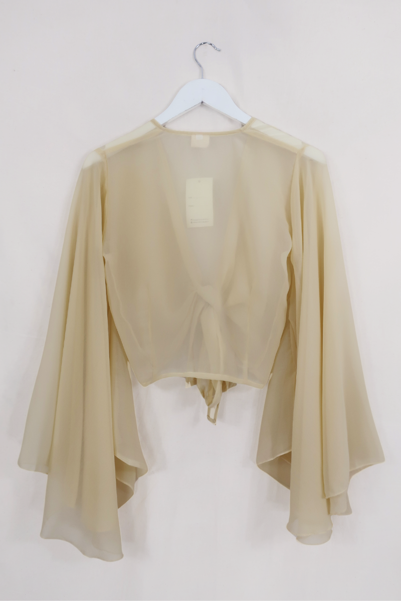 Birgo Shell Virgo Sheer Bell Sleeve Wrap Top | Shell White | All About Audrey – All ...