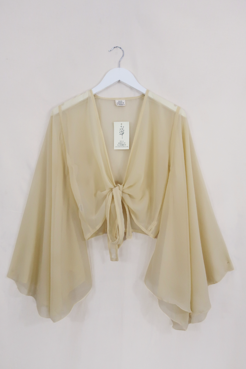 Birgo Shell Virgo Sheer Bell Sleeve Wrap Top | Shell White | All About Audrey – All ...