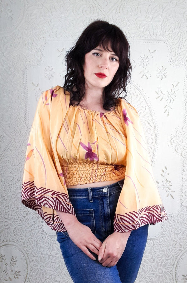 Our stunning model shows a close up of our beautiful Bardot Scorpio top. This gorgeous top features a violet lotus print with a peachy tone background. 
