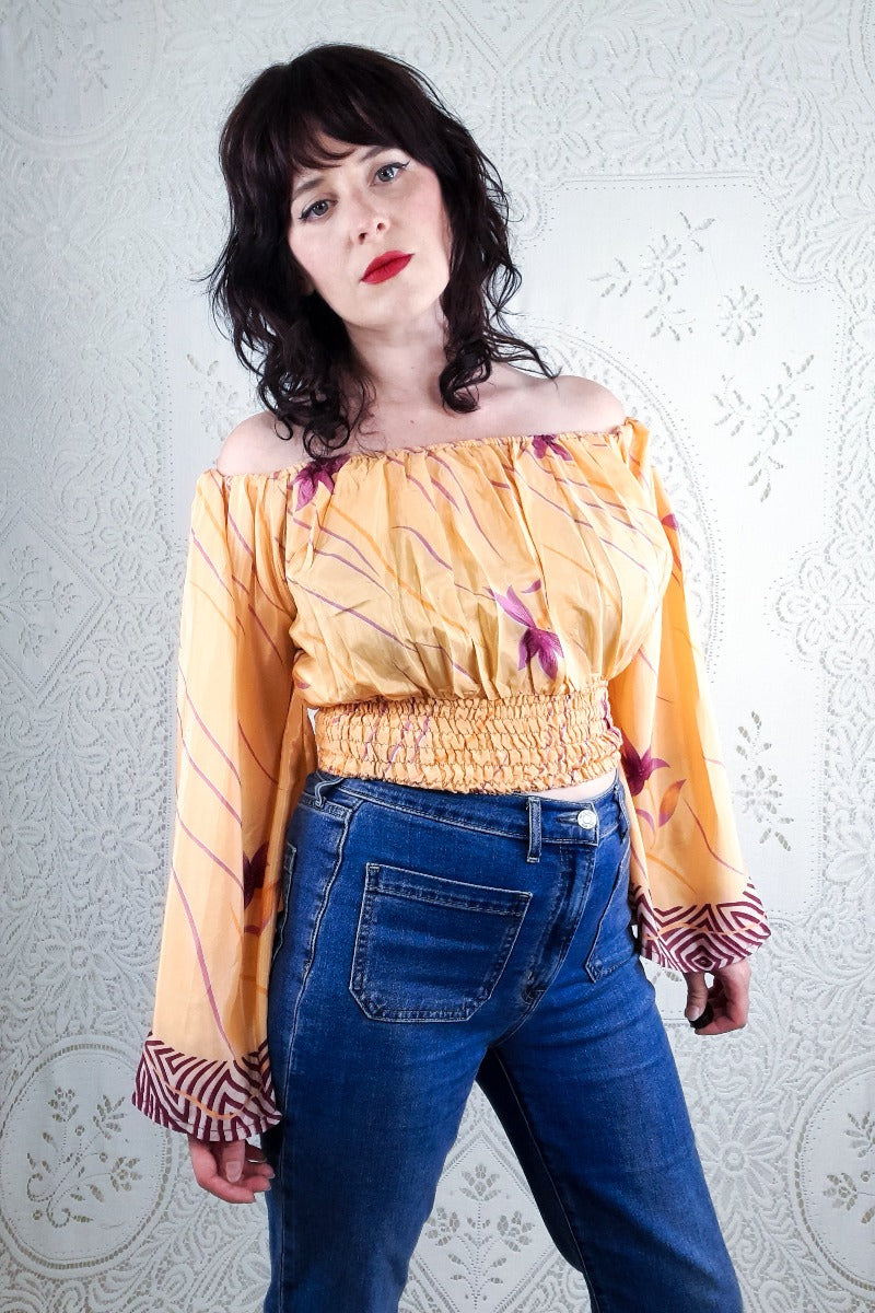 Our stunning model shows a close up of our beautiful Bardot Scorpio top. This gorgeous top features a violet lotus print with a peachy tone background. 